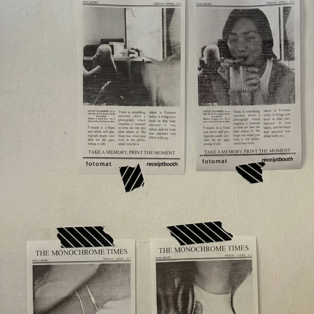 Receipt-style photo prints taped to a wall