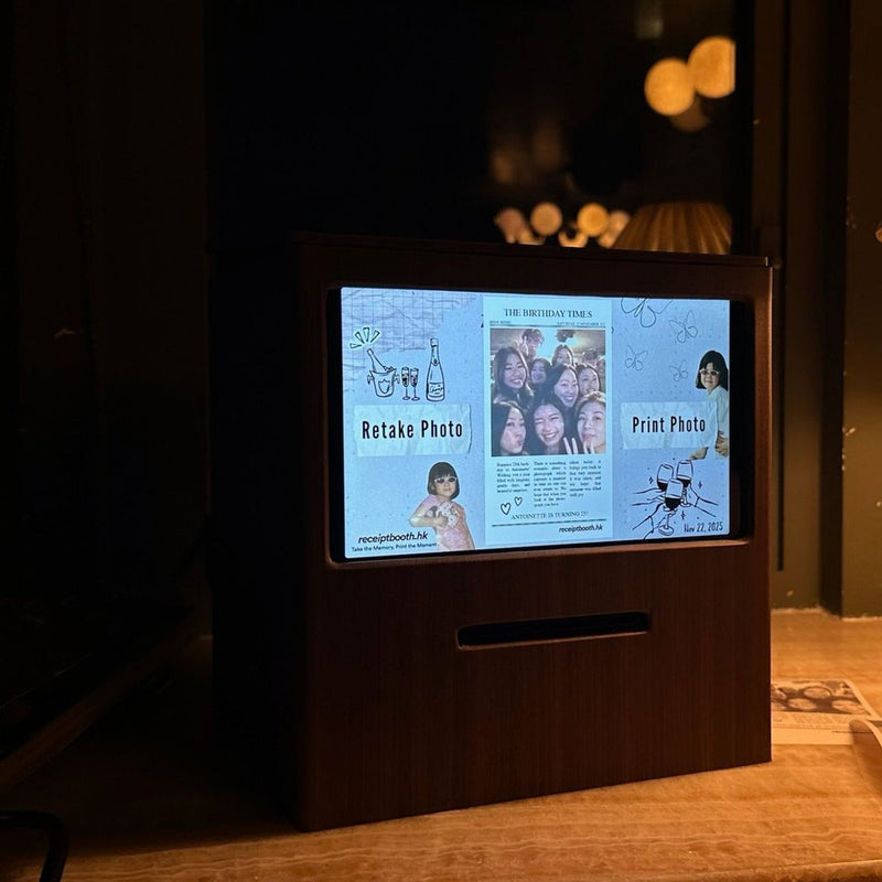 Walnut-finish Receipt Booth with a custom newspaper-style template on its screen and a printed strip on the table
