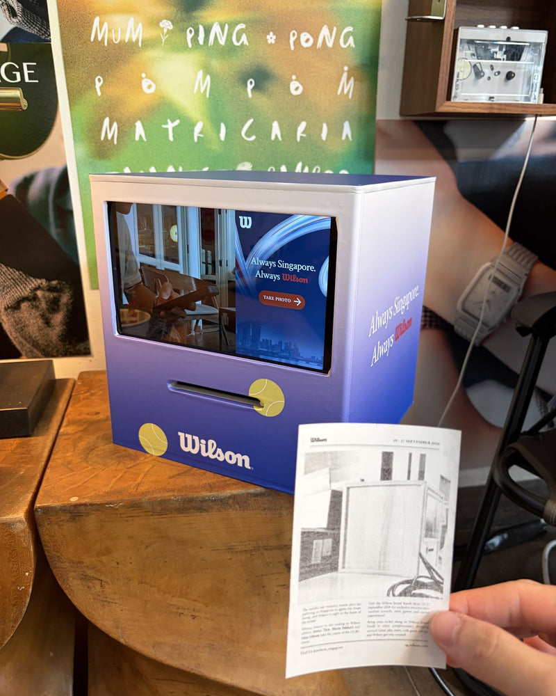 Wilson-branded Receipt Booth with a printed receipt held in front